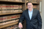 Mark S. Zuckerberg attorney leaning against law office bookshelves