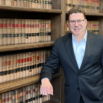 Mark S. Zuckerberg attorney leaning against law office bookshelves