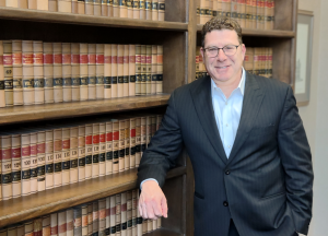 Mark S. Zuckerberg attorney leaning against law office bookshelves